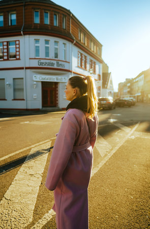 Portrait of young caucasian woman with brunette hair walking on a city street in Europe .の写真素材
