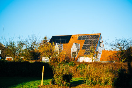 Modern home with installed solar panels. Sun energy source to produce electricity for own needsの写真素材