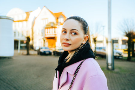 Portrait of young caucasian woman with brunette hair walking on a city street in Europe .の写真素材