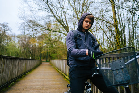 Young caucasian man ride on bicycle in the park.の写真素材
