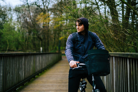 Young caucasian man ride on bicycle in the park.の写真素材