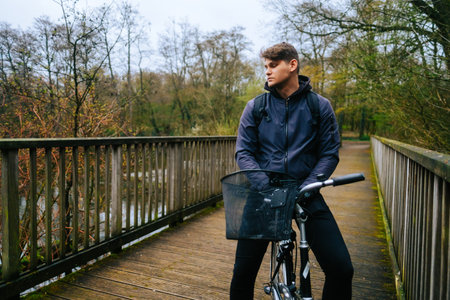 Young caucasian man ride on bicycle in the park.の写真素材