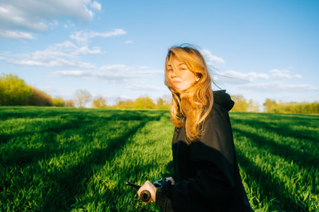 Portrait of young caucasian attractive woman with bicycle at the field in countryside .の写真素材