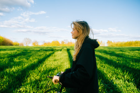 Portrait of young caucasian attractive woman with bicycle at the field in countryside .の写真素材