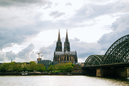 Great St. Martin Church and Kolner Dom with old colorful houses of Cologne and cloudy sky hdr background.の写真素材