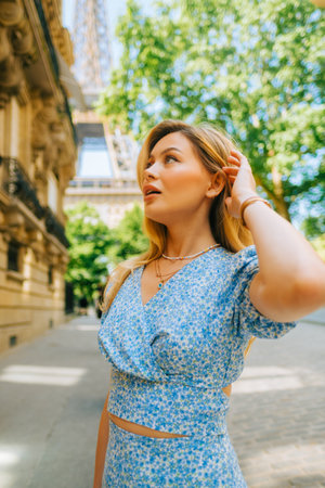 Portrait of young attractive woman fashion model posing near Eiffel Tower in Paris .の写真素材