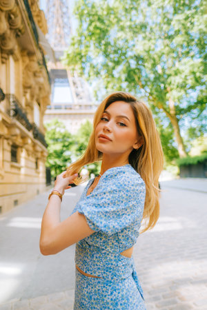 Portrait of young attractive woman fashion model posing near Eiffel Tower in Paris .の写真素材