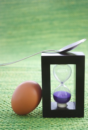 Sand egg timer with boiled eggの写真素材