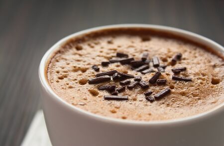 Capuccino in white cup  with chocolate sprinklesの写真素材