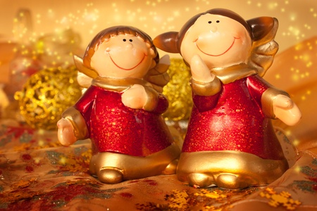 Two Christmas angels on golden settingの写真素材