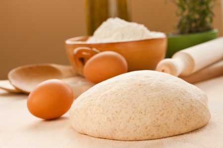 Ball of homemade dough with flour and olive oil in the back.の写真素材