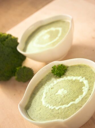 Rich vegetable broccoli soup with cream garnishの写真素材