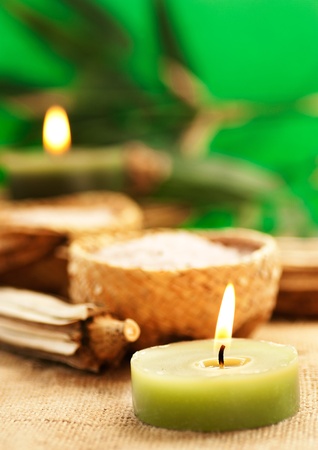 Candle with aromatic bath salt in rustic straw bowls.の写真素材