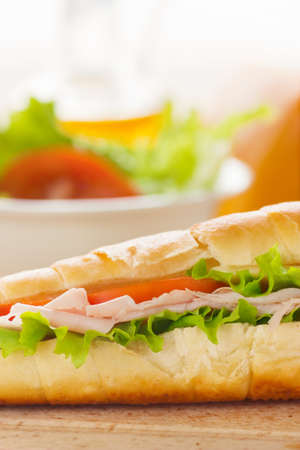 Ham and cheese sandwich with lettuce and tomato.の写真素材