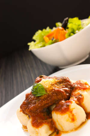 Beef with sauce,  gnocchi and salad.の写真素材