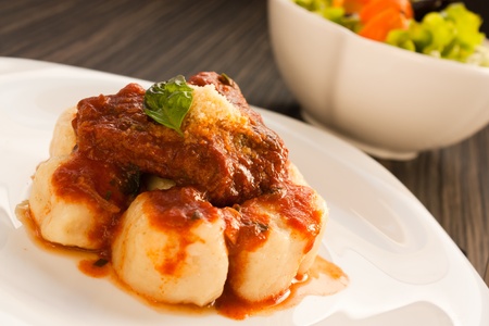 Beef with sauce,  gnocchi and salad.の写真素材