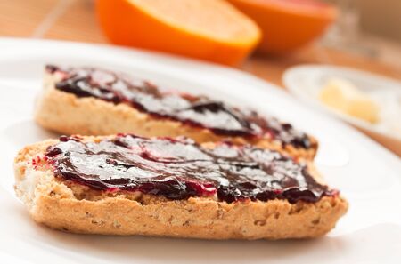 Breakfast with butter and jam and freshly squeezed juice.の写真素材