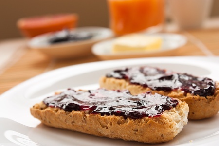 Breakfast with butter and jam and freshly squeezed juice.の写真素材