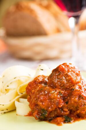 Pasta with tower aranged meatballs in tomato sauceの写真素材