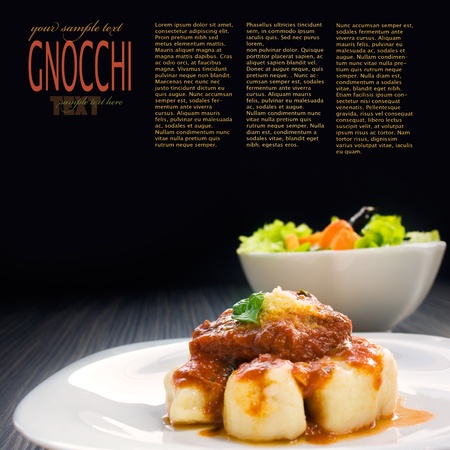 Beef with sauce,  gnocchi and salad.の写真素材