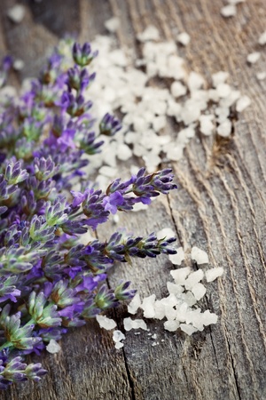 Spa setting with Fresh lavender over wooden background with bath saltの写真素材