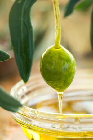 Extra virgin healthy Olive oil with fresh olives on rustic wooden backgroundの写真素材