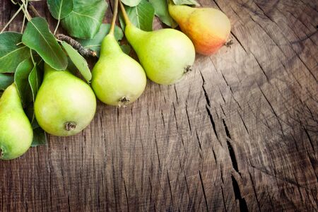 Freshly harvested pears on old wooden backgroundの写真素材