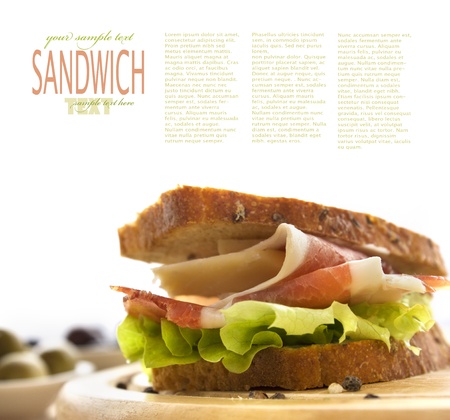 Prosciutto and cheese sandwich with olives and lettuce.の写真素材