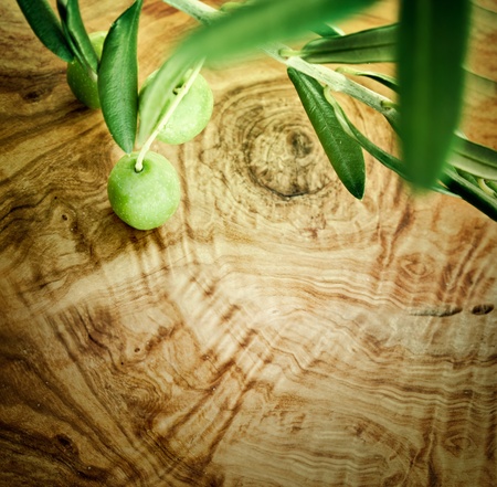 Summer olives nature background with fresh olive branch and olive woodの写真素材