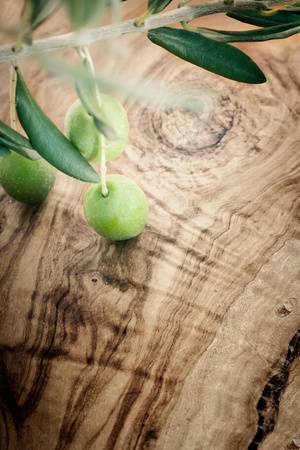 Summer olives nature background with fresh olive branch and olive woodの写真素材