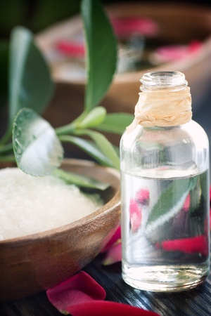 Natural spa setting with rose water and towel.の写真素材