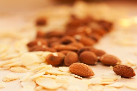 Bunch of almonds with peeled almonds on the wooden boarsの写真素材