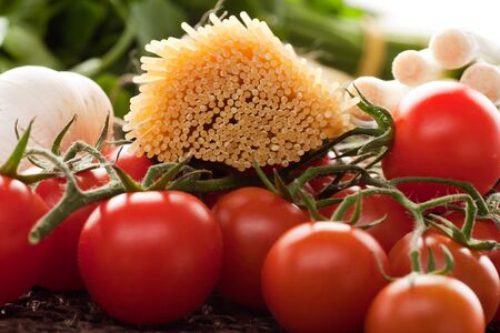 Spaghetti with cherry tomatoes, onions, garlic and parsley. Ingredients for tomato sauce.の写真素材