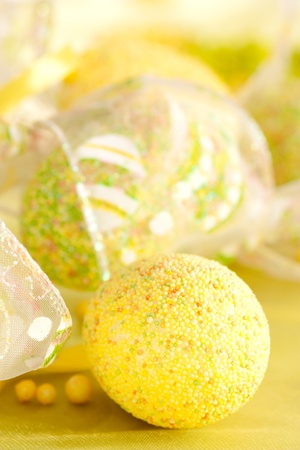 Easter setting with Easter eggs in green and yellowの写真素材