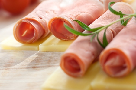 Slices of ham and cheese with rosemary. Selective focusの写真素材