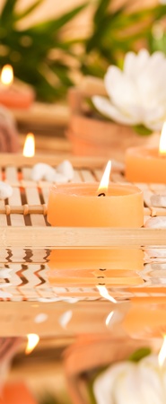 Spa setting withcandles, waterlily and pebblesの写真素材