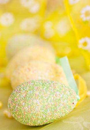 Easter setting with Easter eggs in green and yellowの写真素材