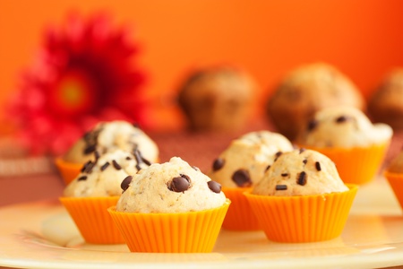 Vanilla muffins with chocolate chips in orange cupsの写真素材