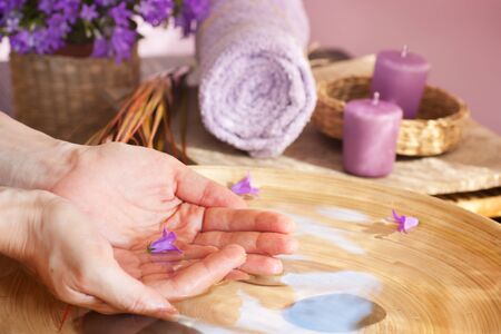 Spa setting with water for treatment and towel.の写真素材