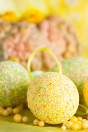 Easter setting with Easter eggs in green and yellowの写真素材