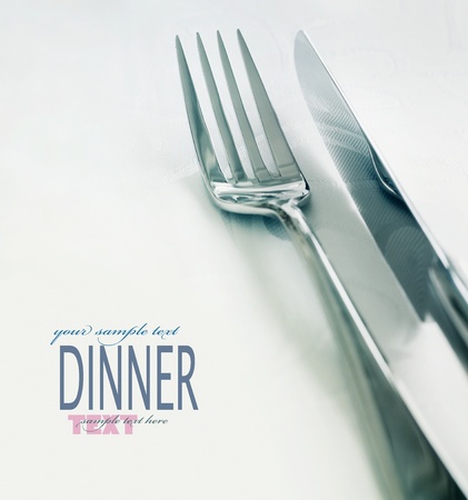 Restaurant menu series. Wedding or dinner table place setting. Fork and knife and glass in elegant setting with copyspaceの写真素材