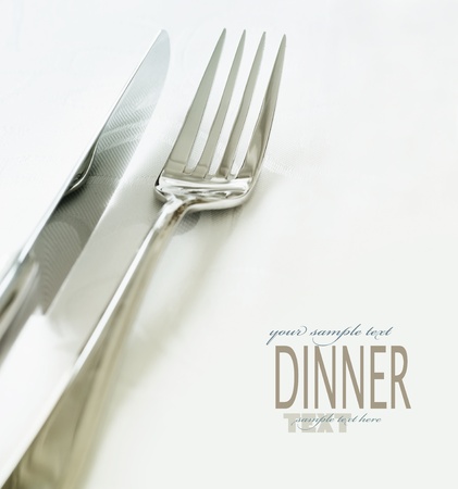 Restaurant menu series. Wedding or dinner table place setting. Fork and knife and glass in elegant setting with copyspaceの写真素材
