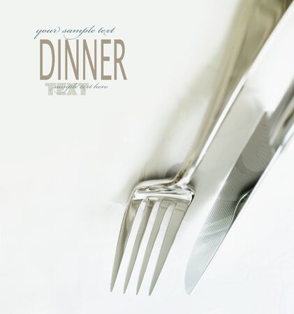 Restaurant menu series. Wedding or dinner table place setting. Fork and knife and glass in elegant setting with copyspaceの写真素材