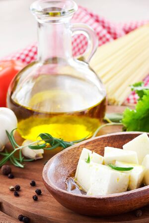 Feta cheese sllices with olive oil and rosemaryの写真素材