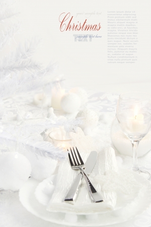 Restaurant series with copyspace. Christmas dinner with table setting in white and holiday ornamentsの写真素材