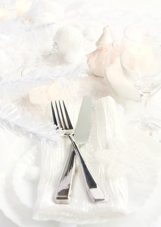 Restaurant series with copyspace. Christmas dinner with table setting in white and holiday ornamentsの写真素材