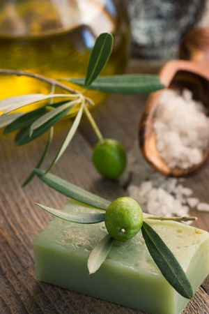 Natural spa setting with olive  and olive oil products: bath salt, natural soap and olive oil.の写真素材
