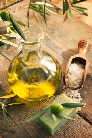 Natural spa setting with olive  and olive oil products: bath salt, natural soap and olive oil.の写真素材