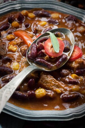 Chili con carne plate. Mexican traditional dish in rustic settingの写真素材