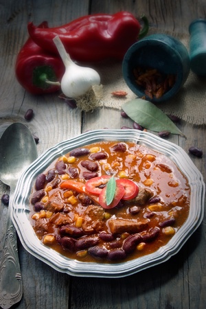 Chili con carne plate. Mexican traditional dish in rustic settingの写真素材